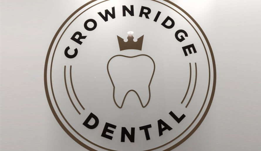 Crownridge Dental logo on dental office wall