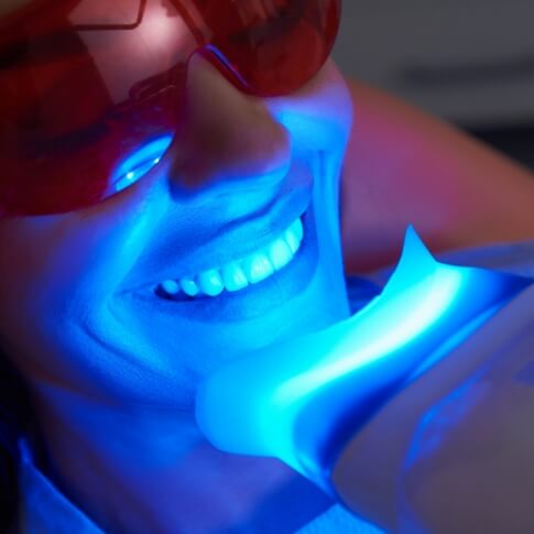 Dental patient receiving teeth whitening treatment