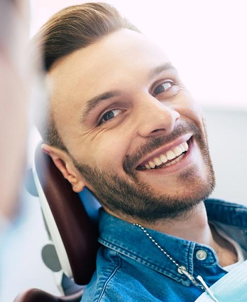 smiling dental implant patient in chair