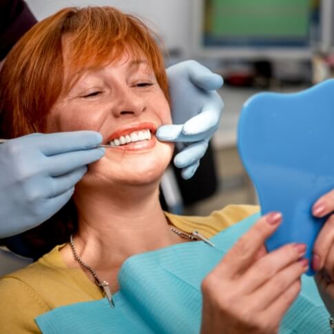Smiling woman enjoying the benefits of dental implants