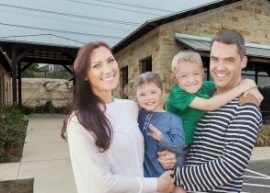 Family smiling outside of dental office