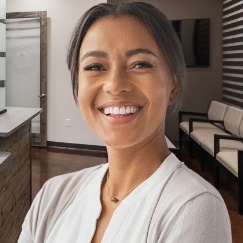 Smiling woman wearing white blouse