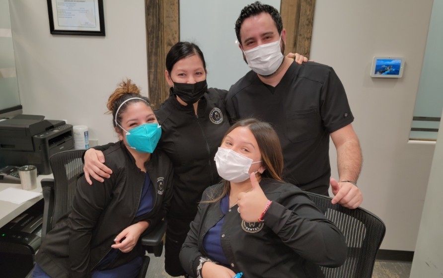 Four smiling Crownridge Dental team members