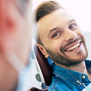 Man smiling while relaxing in treatment chair