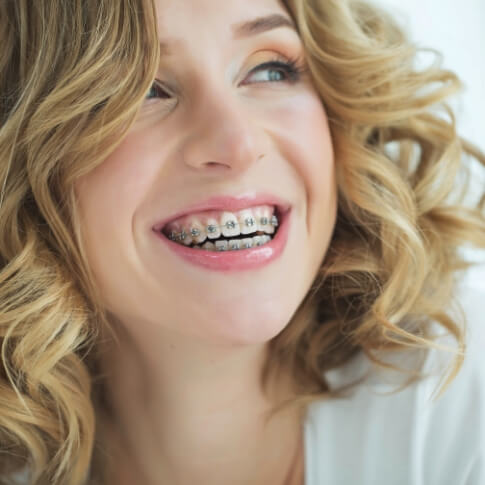 Smiling woman with traditional braces