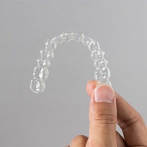 Patient holding clear aligner