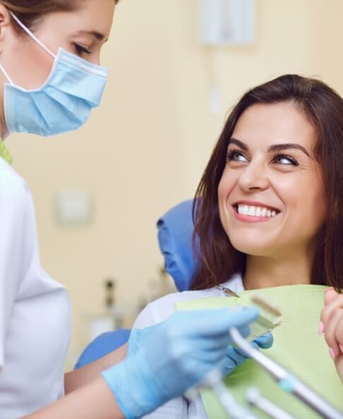 Woman smiling during restorative dentistry treatment