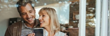 Man and woman with healthy smiles after preventive dentistry