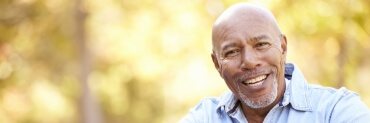 Man sharing full smile after replacing missing teeth