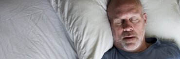 Man sleeping soundly thanks to sleep apnea treatment