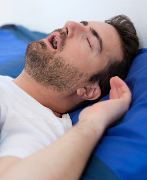 Snoring man in need of sleep apnea treatment