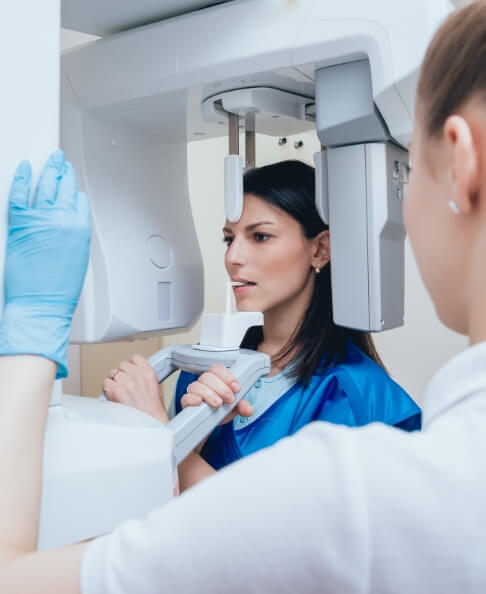 Dental team member receiving dentistry treatment using advanced dental services and technology