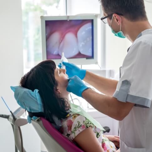 Dentist using intraoral camera to capture smile images