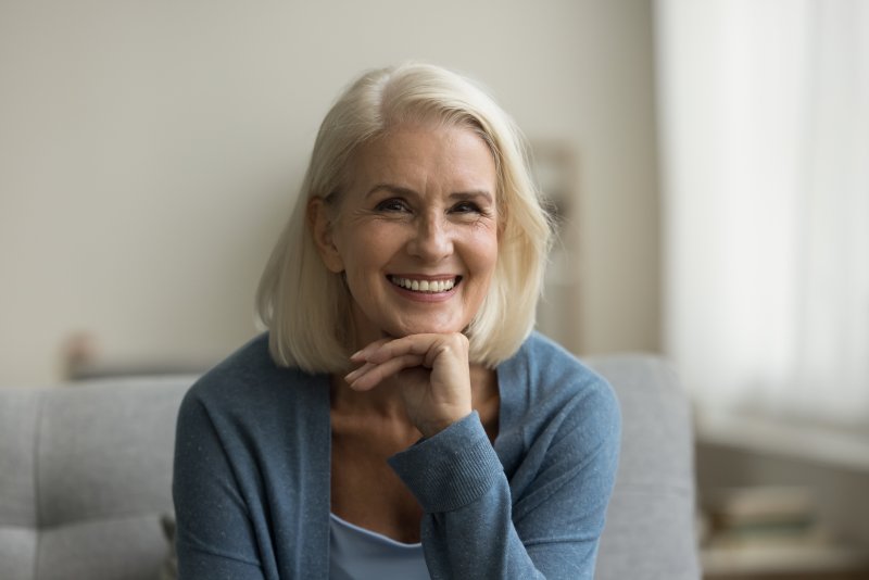 a mature woman smiling with new dental implants